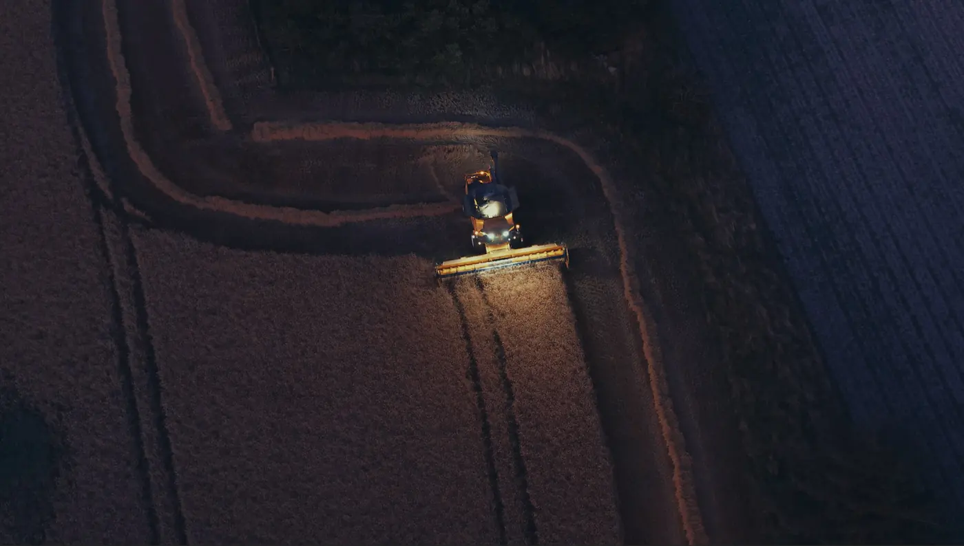 Aerial view of a combine harvesting at night